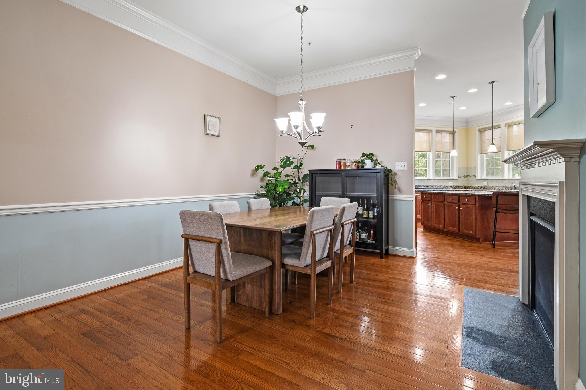 8722 Polished Pebble Way Laurel, MD 20723 - Photo 10 of 58 a dining room with furniture a chandelier and wooden floor