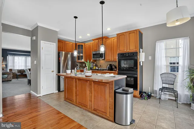 a kitchen with stainless steel appliances granite countertop a stove and refrigerator