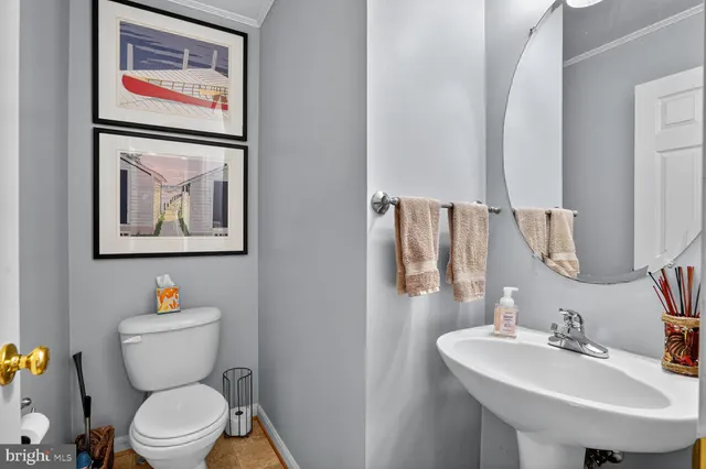 a bathroom with a toilet a sink and a mirror