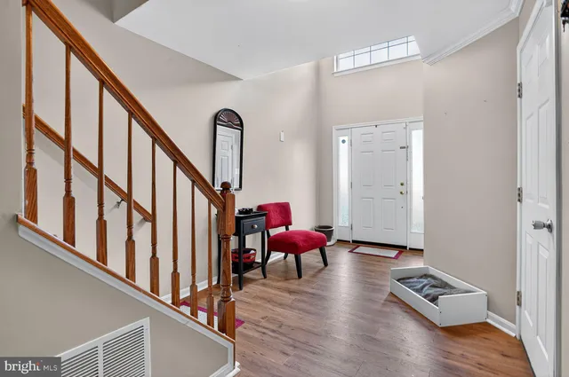 a view of an entryway with wooden floor and door