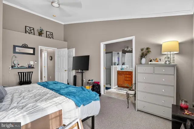 a bedroom with a bed and a flat tv screen in it