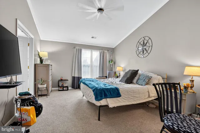 a bedroom with furniture and a flat screen tv