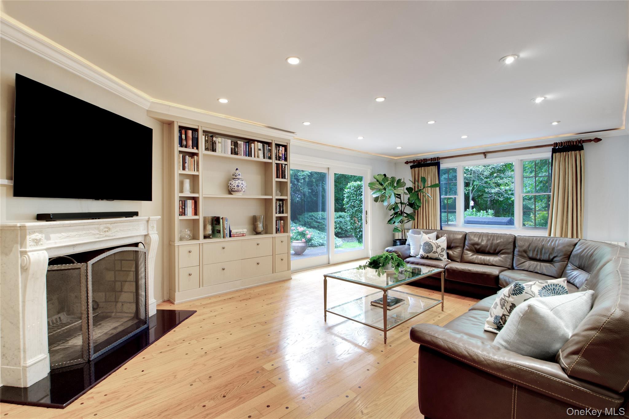 4 Kimson Court Manhasset, NY 11030 - Photo 12 of 30 a living room with furniture fireplace and flat screen tv