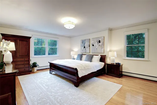a bedroom with a bed lamp closet mirror and a window
