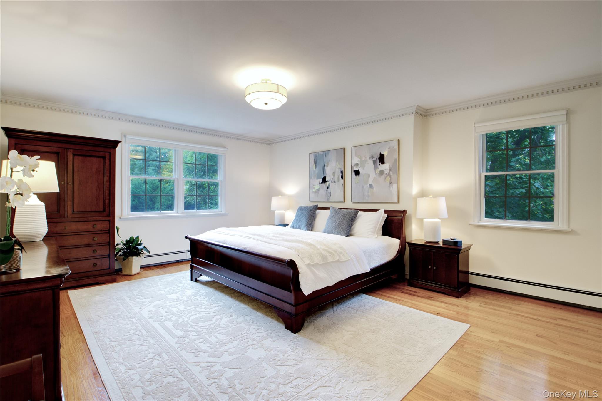 4 Kimson Court Manhasset, NY 11030 - Photo 15 of 30 a bedroom with a bed lamp closet mirror and a window