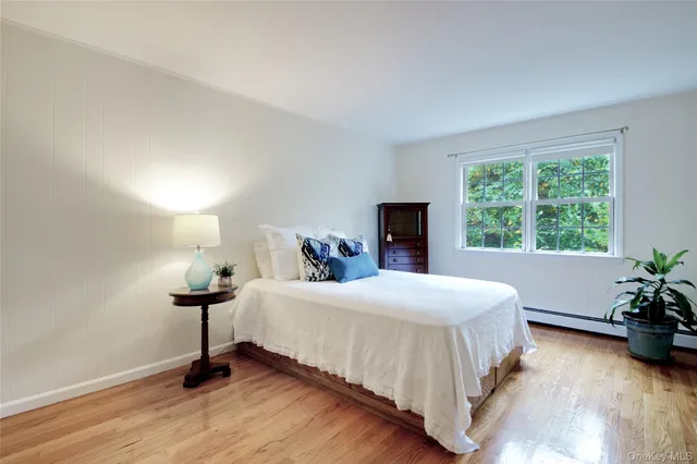 a bedroom with a bed and a potted plant
