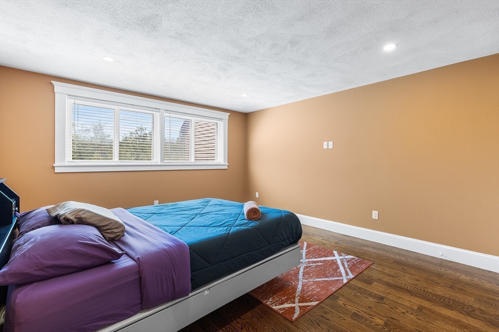 1100 Salem Street, Unit 93 Peabody, MA 01960 - Photo 16 of 27 a bedroom with a bed and wooden floor
