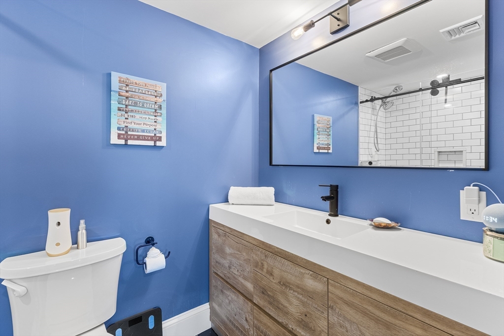 1100 Salem Street, Unit 93 Peabody, MA 01960 - Photo 19 of 27 a bathroom with a sink mirror and toilet