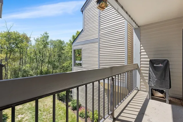 a view of a balcony with chair and wooden floor
