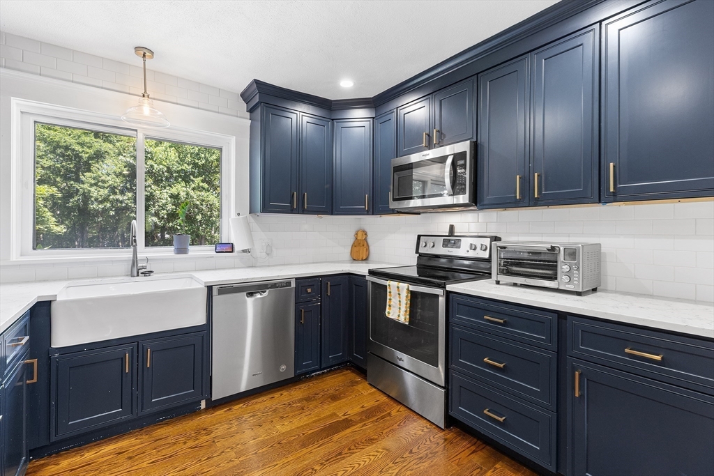 1100 Salem Street, Unit 93 Peabody, MA 01960 - Photo 4 of 27 a kitchen with stainless steel appliances granite countertop wooden cabinets and a stove top oven