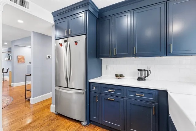a kitchen with a refrigerator and cabinets