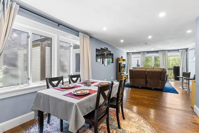 a view of a dining room with furniture window and wooden floor
