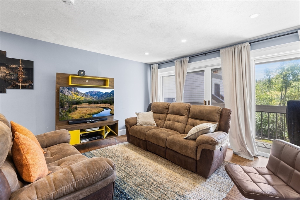 1100 Salem Street, Unit 93 Peabody, MA 01960 - Photo 8 of 27 a living room with furniture and a flat screen tv