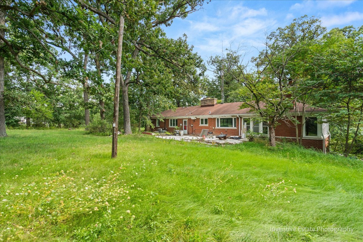 23000 Sherman Road Steger, IL 60475 - Photo 4 of 9 a front view of a house with a yard