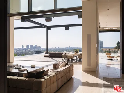 a living room with furniture and a floor to ceiling window
