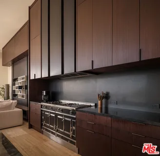 a kitchen with stainless steel appliances wooden cabinets and a stove top oven