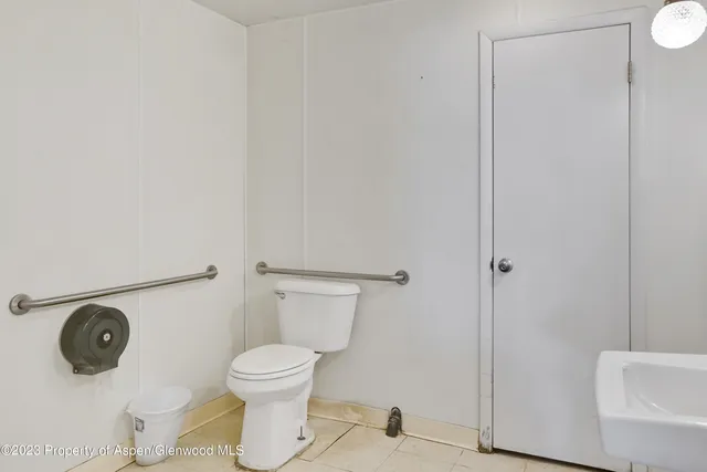 a view of staircase with railing and white walls