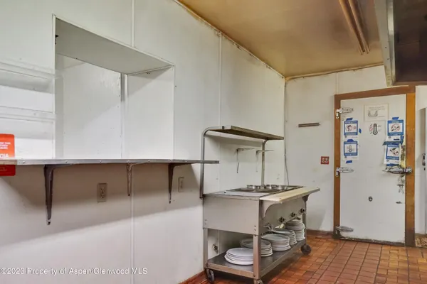 a kitchen with a refrigerator and a sink