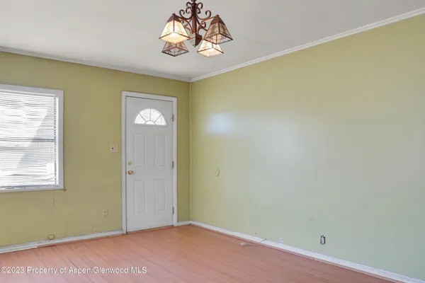 a view of an empty room and wooden floor
