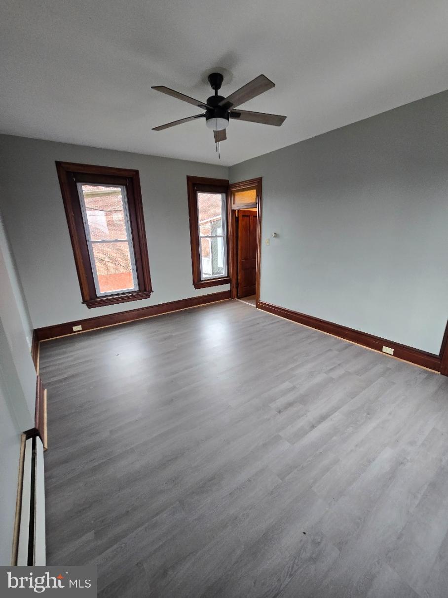 40 South 11th Street Lebanon, PA 17042 - Photo 9 of 11 an empty room with wooden floor chandelier fan and windows