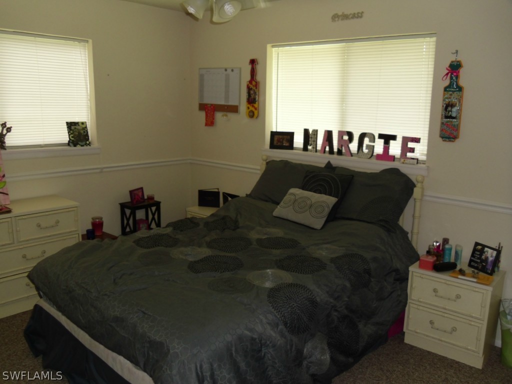 18583 Evergreen Road Fort Myers, FL 33967 - Photo 12 of 17 a bed sitting in a bedroom next to a window
