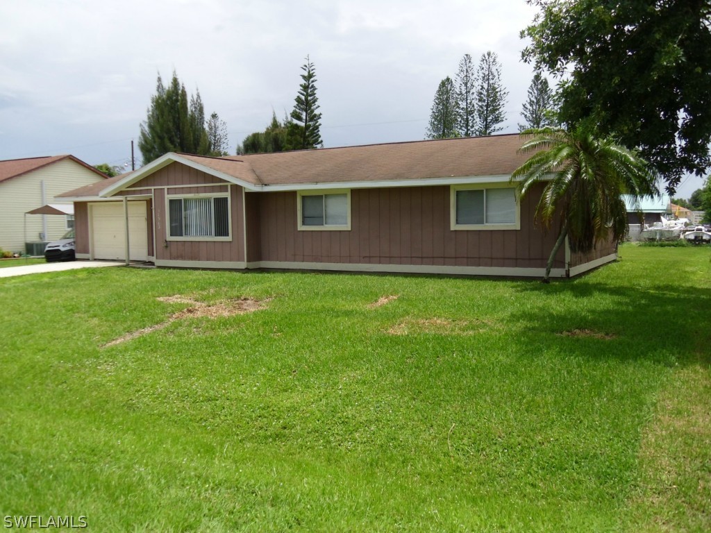 18583 Evergreen Road Fort Myers, FL 33967 - Photo 5 of 17 a front view of a house with a yard