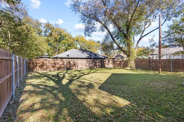 a view of a yard with large trees
