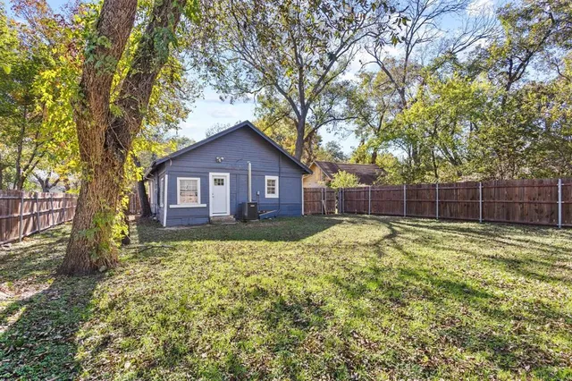 a large tree in front of a house with a large tree