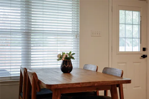 a view of a dining room with furniture and window