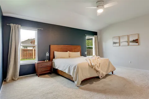 a bedroom with a bed dresser and a window