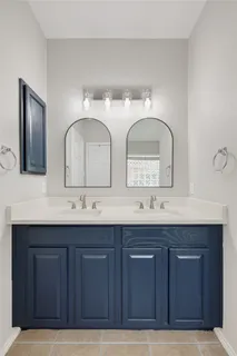 a bathroom with double sink and a mirror