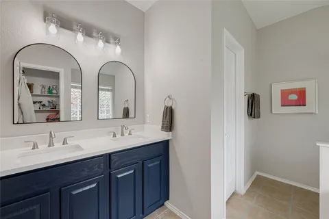 a bathroom with a double vanity sink and a mirror