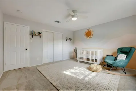 a view of a livingroom with a chair and white walls