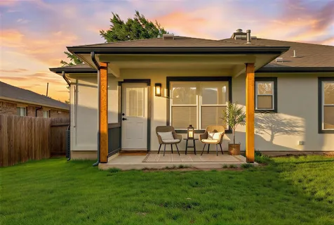 a view of a porch with a table and chairs