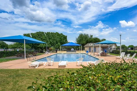 a view of a backyard with swimming pool