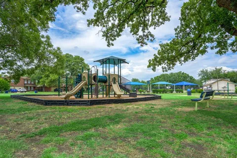 a view of a park with large trees