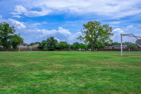 a view of a garden with a building in the background