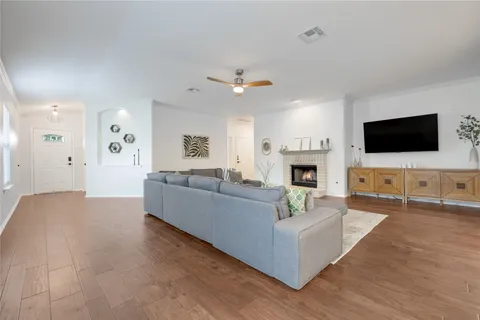 a living room with fireplace furniture and a flat screen tv