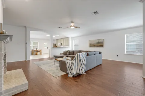 a living room with furniture wooden floor and a window