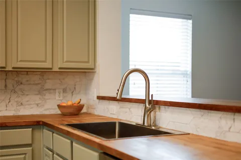 a kitchen with a sink and cabinets