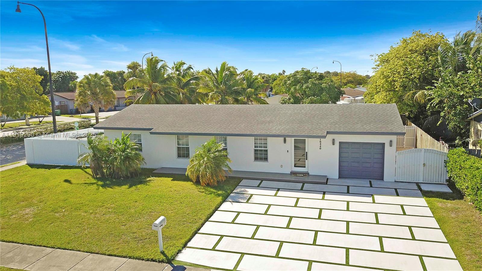 15440 Southwest 102nd Place Miami, FL 33157 - Photo 2 of 30 a front view of a house with a yard