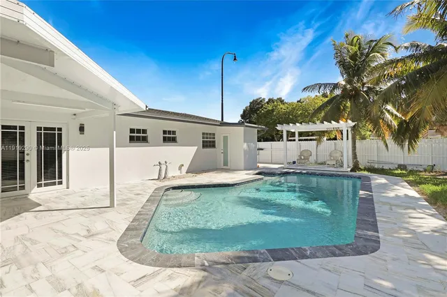 a view of a house with a backyard