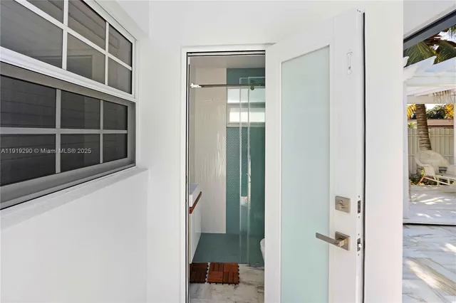 a view of a hallway with windows and closet