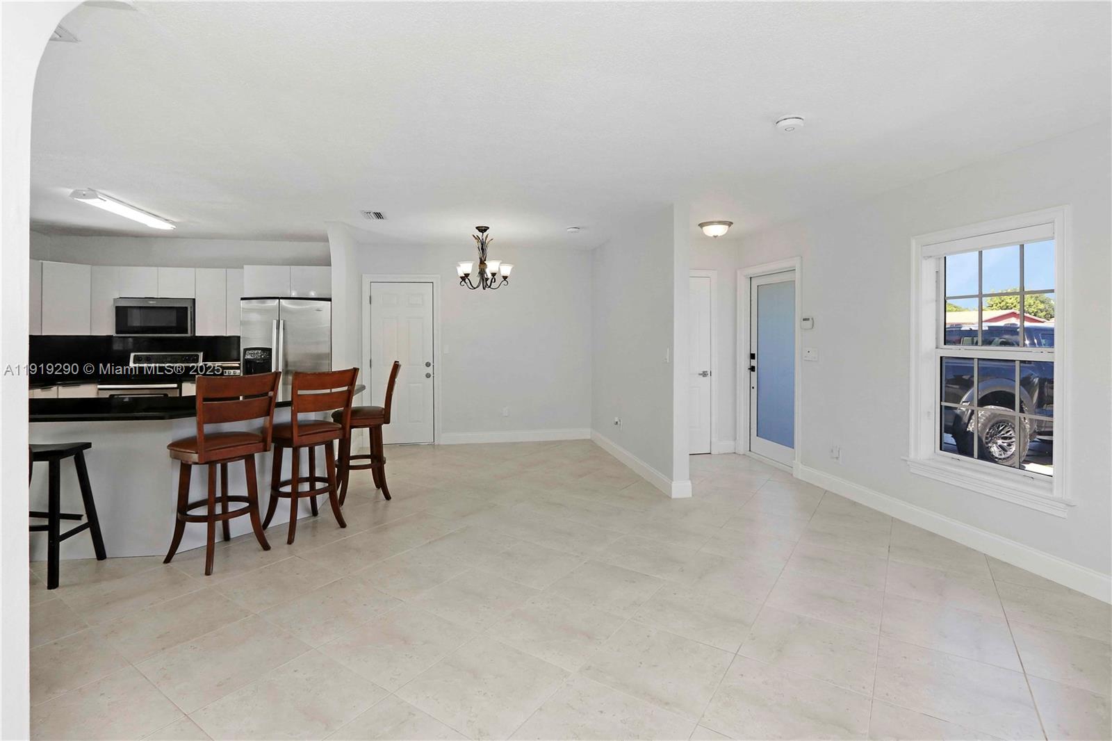 15440 Southwest 102nd Place Miami, FL 33157 - Photo 5 of 30 a view of a kitchen with dining room and wooden floor