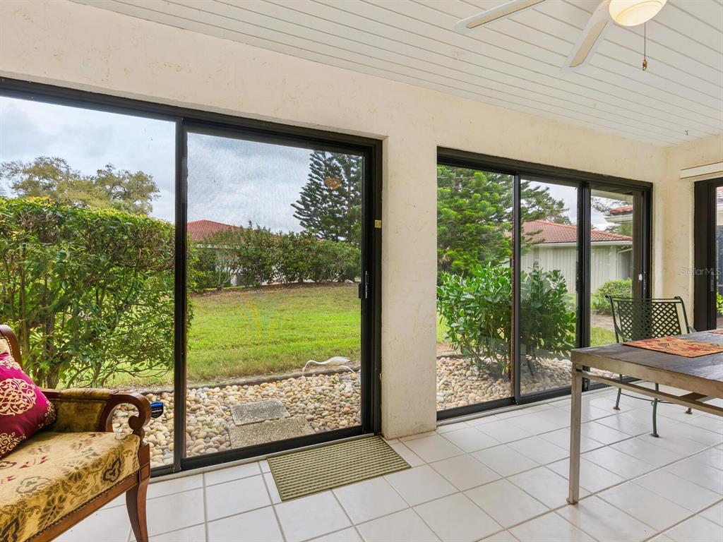 5107 Greencroft Road, Unit 23 Sarasota, FL 34235 - Photo 13 of 35 a view of a room with furniture and floor to ceiling window