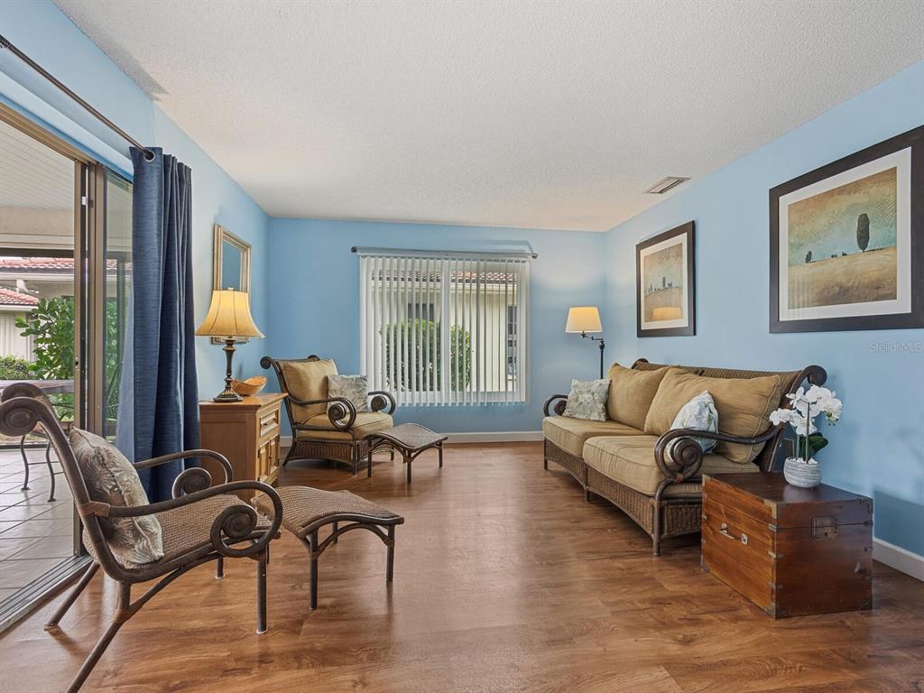 5107 Greencroft Road, Unit 23 Sarasota, FL 34235 - Photo 14 of 35 a living room with furniture and a large window
