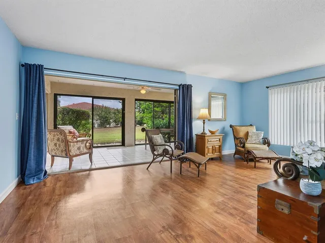 a living room with furniture and large windows