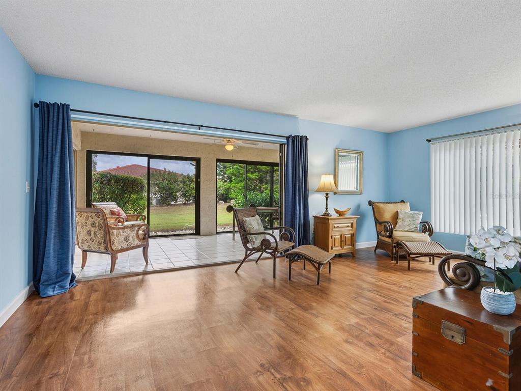 5107 Greencroft Road, Unit 23 Sarasota, FL 34235 - Photo 2 of 35 a living room with furniture and large windows