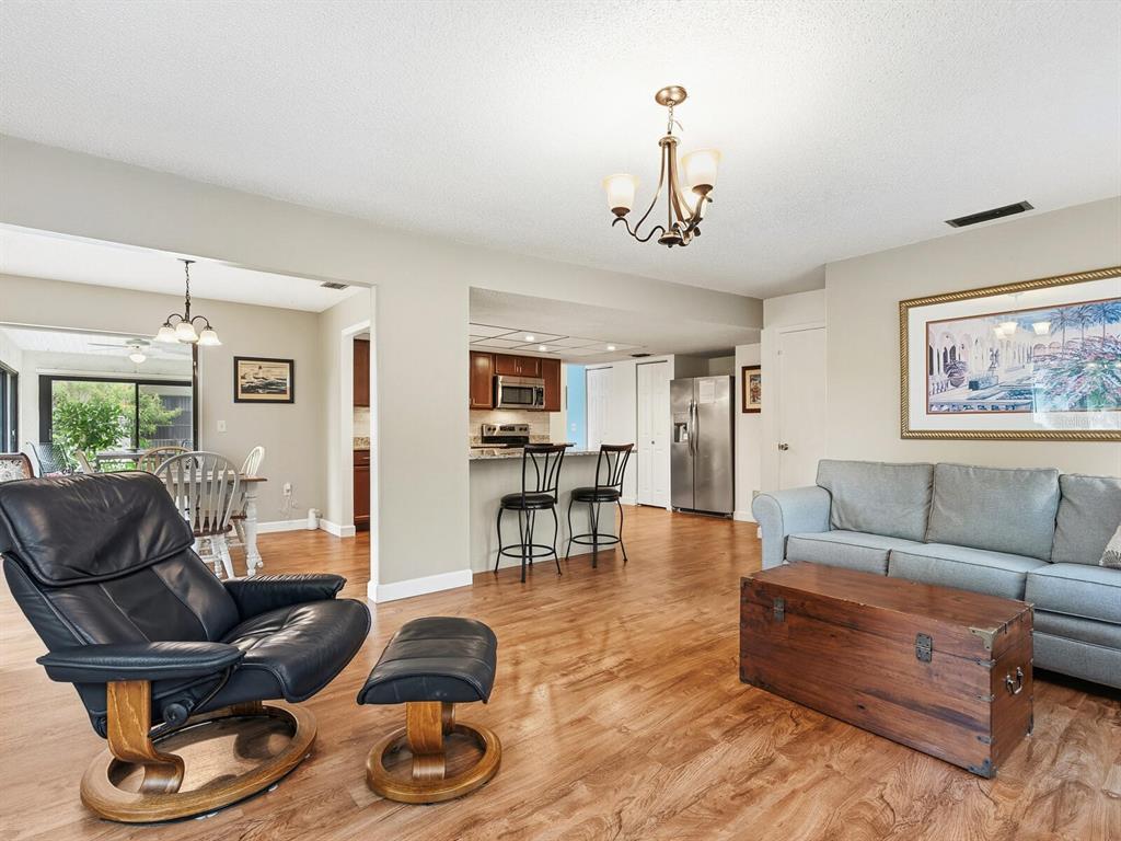 5107 Greencroft Road, Unit 23 Sarasota, FL 34235 - Photo 6 of 35 a living room with furniture and wooden floor