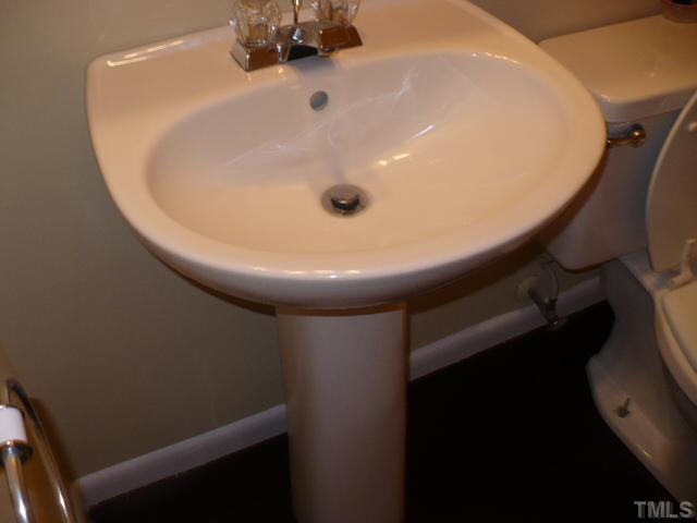 814 Green Ridge Drive Raleigh, NC 27609 - Photo 4 of 7 a bathroom with a sink and mirror